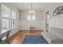 Bright dining room with hardwood floors, wainscoting, and modern light fixture at 1006 Whistler St, Durham, NC 27713