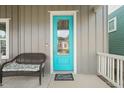 Close-up of the bright blue front door with 'Home Sweet Home' welcome mat at 1006 Whistler St, Durham, NC 27713