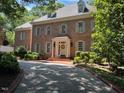 Beautiful brick two-story home featuring manicured landscaping and a welcoming front entrance with wreath at 1105 Tazwell Pl, Raleigh, NC 27612