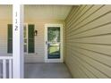 Close up of the front door and the address number of the home on a sunny day at 112 Avent Pines Ln, Holly Springs, NC 27540