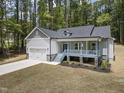 Inviting new home with covered porch, 2-car garage and a beautifully landscaped front yard at 113 Pueblo Dr, Louisburg, NC 27549