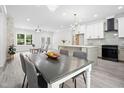 Spacious open concept kitchen features modern appliances, a large island and a connected dining area at 113 Pueblo Dr, Louisburg, NC 27549