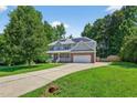 Charming two-story home featuring a brick and siding facade, solar panels, and a wide driveway at 1205 Magnolia Hill Rd, Garner, NC 27529