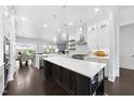 Bright kitchen with a marble topped island, stainless steel appliances and open layout at 129 Damsire Way, Cary, NC 27513