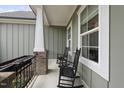 Cozy front porch with rocking chairs, perfect for relaxing and enjoying the outdoors at 129 Damsire Way, Cary, NC 27513