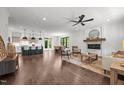 Open-concept living room featuring a fireplace, hardwood floors, and seamless flow to the kitchen at 1317 Fay St, Durham, NC 27701