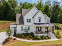 Charming two-story home with a covered porch and a neatly manicured landscape at 1344 Legend Oaks Dr, Chapel Hill, NC 27517