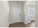 Bright foyer with white door, hardwood floors, and glass-paneled door leading to another room at 136 Pisgah St, Sanford, NC 27330