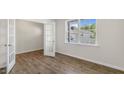 Open office space with hardwood floors, natural light, and glass-paneled door at 136 Pisgah St, Sanford, NC 27330