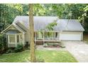 Attractive single-story home featuring an attached garage, covered front porch, and lush green lawn at 140 Baron Cir, Youngsville, NC 27596