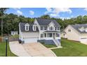 Beautiful two-story home with dormer windows, shutters, a front porch, and a two-car garage at 149 Great Oak Dr, Garner, NC 27529