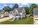 Lovely two-story home with a two-car garage, a welcoming porch, and a green lawn at 149 Great Oak Dr, Garner, NC 27529