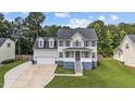 Charming two-story home with a well-manicured lawn, a two-car garage, and a welcoming front porch at 149 Great Oak Dr, Garner, NC 27529