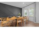 Bright dining room features modern decor, a striking accent wall, and a large window with natural light at 165 Hickory Grv Dr, Sanford, NC 27330