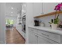 Modern kitchen with white cabinets, stainless steel appliances, and a view of the dining area at 165 Hickory Grv Dr, Sanford, NC 27330