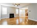 Bright living room with hardwood floors, a fireplace, and large windows offering plenty of natural light at 165 Sutherland Dr, Franklinton, NC 27525