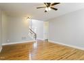 Open living area with hardwood floors, a ceiling fan, and stairs to the second floor at 165 Sutherland Dr, Franklinton, NC 27525
