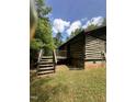 Rustic log cabin home showcasing a charming wooden deck and classic design at 2011 Bowmantown Rd, Roxboro, NC 27574