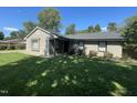 Single story home showing the fresh landscaping, neutral color scheme, and well kept yard at 205 Woodhaven Dr, Burlington, NC 27217