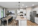 Bright kitchen with stainless steel appliances and granite countertops at 2301 Edenberry Ln, Fuquay Varina, NC 27526