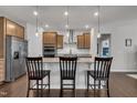 Modern kitchen featuring stainless steel appliances, granite countertops, and a stylish island with bar seating at 2626 Nassau Trce, Fuquay Varina, NC 27526