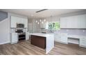 Bright kitchen with white cabinets, stainless appliances, and a large island at 2725 Gross Ave, Wake Forest, NC 27587