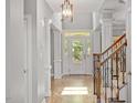 Bright and airy foyer featuring hardwood floors, elegant columns, and a staircase with wood railings at 2941 Grandview Heights Lane Ln, Raleigh, NC 27614