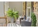 Cozy porch seating area with cushioned chairs, a decorative rug, and lush greenery for a relaxing outdoor space at 2941 Grandview Heights Lane Ln, Raleigh, NC 27614