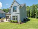 A two-story home with a well-maintained lawn and landscaping, offering a serene suburban setting with trees around it at 335 Glenn St, Franklinton, NC 27525