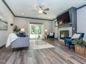 Comfortable living room featuring a fireplace, TV, ceiling fan, modern furniture, and sliding glass door leading outside at 335 Glenn St, Franklinton, NC 27525