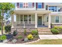 Inviting front porch featuring stone accents and a cozy seating area, enhancing curb appeal at 3504 Regent Pines Dr, New Hill, NC 27562