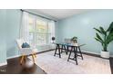 Bright office space featuring a large window, modern desk, and elegant decor, perfect for productivity at 3504 Regent Pines Dr, New Hill, NC 27562