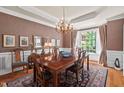 Formal dining room featuring hardwood floors, natural light, and a chandelier at 3606 Dairy Pond Pl, Durham, NC 27705