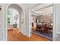 Elegant dining room with hardwood floors, chandelier, and access to the living room at 3606 Dairy Pond Pl, Durham, NC 27705