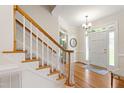 Light-filled foyer showcases hardwood floors, staircase, and a welcoming front door at 4309 Omni Pl, Raleigh, NC 27613