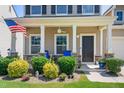 Cozy front porch with decorative stone accents, a ceiling fan, and colorful landscaping at 437 Excalibur Dr, Morrisville, NC 27560
