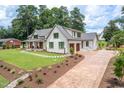 Expansive home with a well-manicured lawn, circular driveway, and attached garage for added convenience at 4412 Pamlico Dr, Raleigh, NC 27609