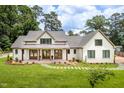 Beautiful, bright home featuring a manicured lawn, walkway to the entryway, and a stylish, covered porch at 4412 Pamlico Dr, Raleigh, NC 27609