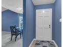 Inviting entryway featuring blue walls, a white front door, and views into the dining area at 4600 Townesbury Ln, Raleigh, NC 27612