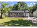Charming single-story home featuring a freshly painted exterior and a well-manicured front lawn at 506 W Walnut St, Selma, NC 27576