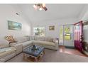 Bright living room with a comfortable sectional sofa, natural light, and stylish decor at 509 Par Dr, Nashville, NC 27856