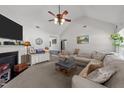 Spacious living room with a vaulted ceiling, fireplace, and a comfortable seating arrangement at 509 Par Dr, Nashville, NC 27856