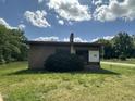 Front exterior view of a brick building on a sunny day showing the flat roof, windows, and lawn at 5934 Boston Rd, Roxboro, NC 27574