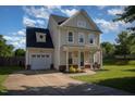 Exterior elevation showcasing a two-story home with a front porch and attached garage at 605 Bellefont Ct, Knightdale, NC 27545