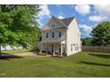Two-story home with landscaped front yard, attached garage, and covered porch at 605 Bellefont Ct, Knightdale, NC 27545