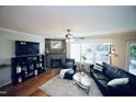 Bright living room with hardwood floors, stone fireplace, and comfortable seating area at 6229 Saybrooke Dr, Raleigh, NC 27604