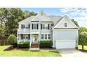 Charming two-story home with a welcoming entrance, well-manicured lawn, and a spacious two-car garage at 626 Toledo Ct, Rolesville, NC 27571