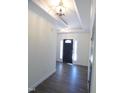 Bright foyer with dark front door, wood floor, and crown molding welcomes you into the home at 776 Shadetree Rd, Benson, NC 27504