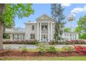 Charming two-story home with columned facade and landscaped yard at 7920 E Washington St, Mebane, NC 27302