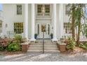 Elegant front entrance with grand pillars, a glass door, and meticulously manicured landscaping at 7920 E Washington St, Mebane, NC 27302